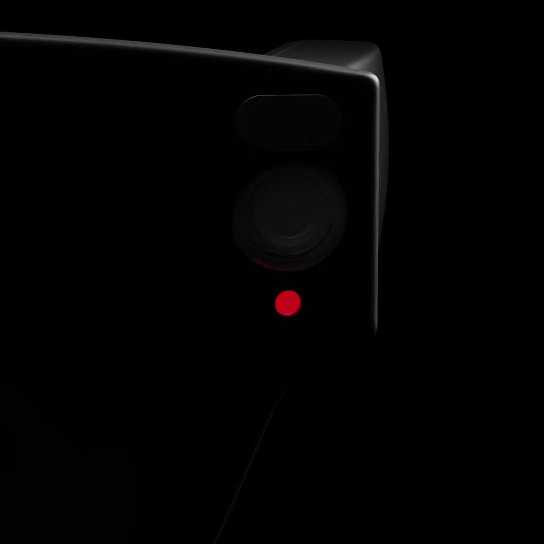 Close-up of the frame beside the camera, with the red recording light on.